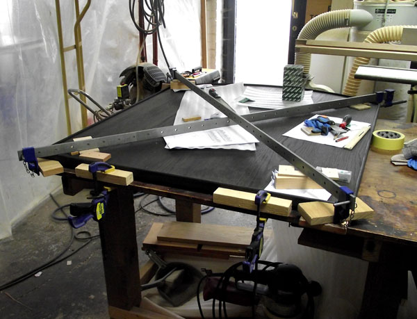 Fixing hockey stick shaped hardwood moulding to a curved top honours board.