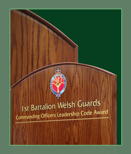 Close up view of a oak honours board with a curved frame produced for the 1st Battalion of the Welsh Guards.