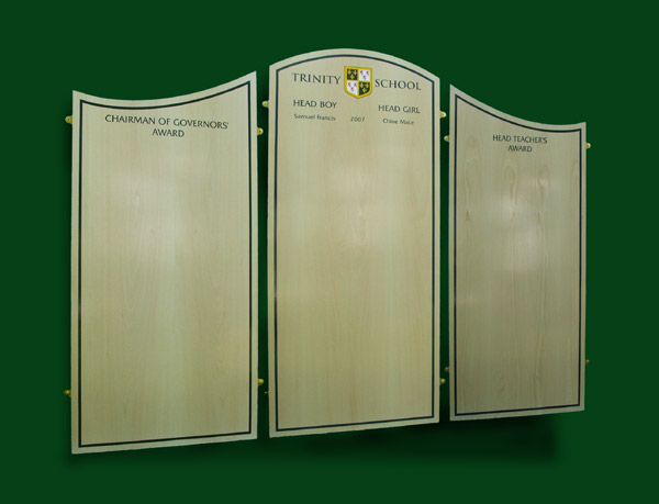 Three pale beech veneered panels with navy blue lettering form a triptych honours board for Trinity School in Erith Kent