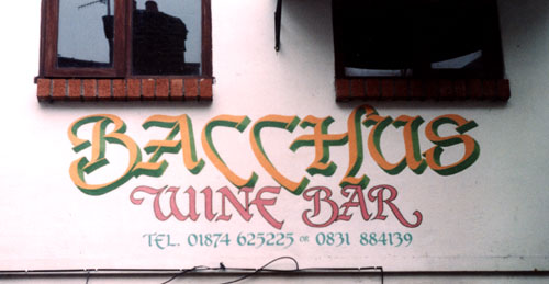 Signwriting on shop front above fascia of Bacchus Wine Bar