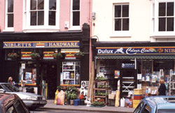 Traditional signwriting on exterior MDF shop front signboard