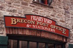 Traditional signwriting on exterior MDF shop front signboard